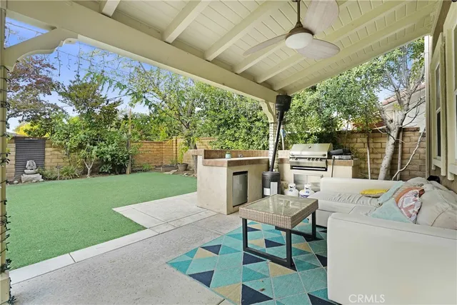 a view of a patio with a table chairs and a backyard