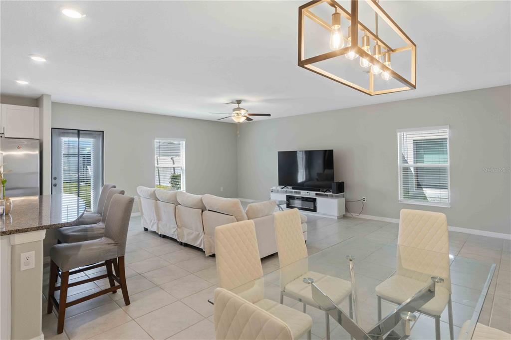 9440 Lemon Drop Loop Sun City Center, FL 33573 - Photo 17 of 55 a living room with furniture a flat screen tv and a large window