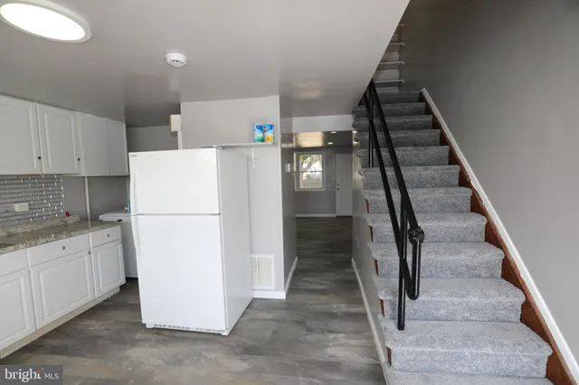a utility room with cabinets washer and dryer