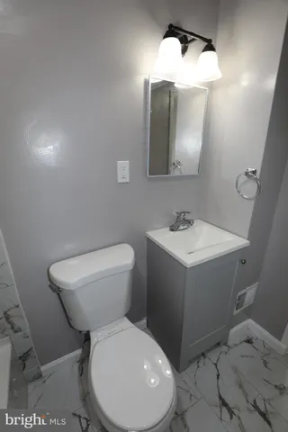 a white toilet sitting next to a bathroom sink