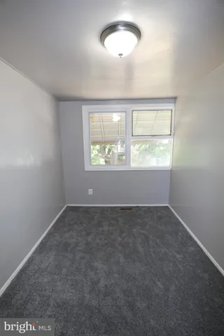 an empty room with a empty space and windows