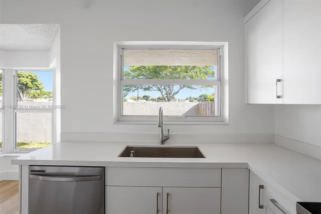 a kitchen with a sink and window