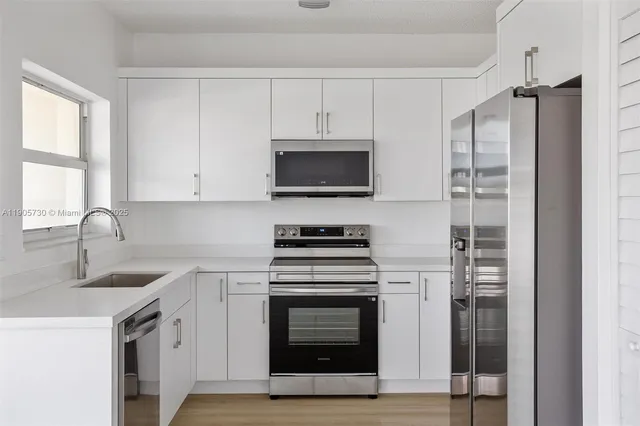 a kitchen with stainless steel appliances granite countertop a stove and a sink