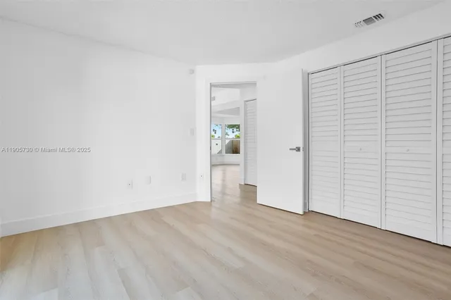 an empty room with wooden floor
