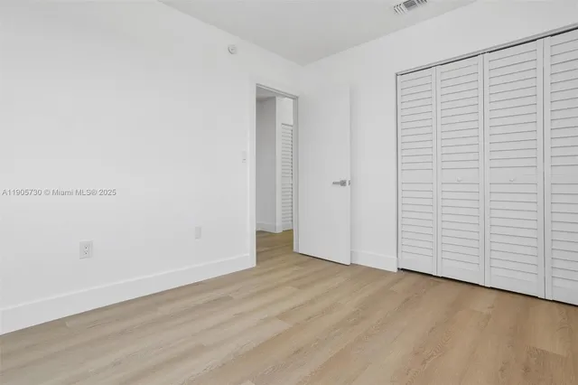 an empty room with wooden floor
