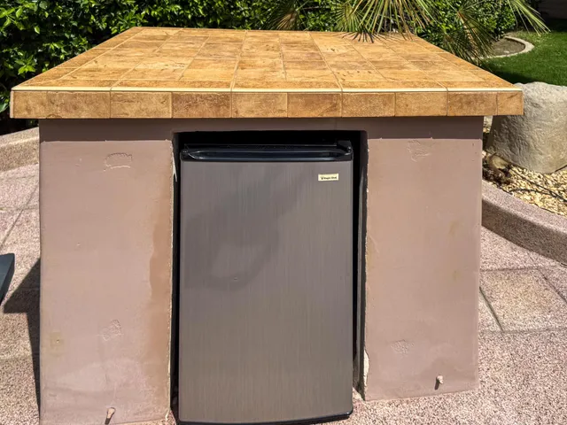 a bathroom with a granite countertop sink and a white stove