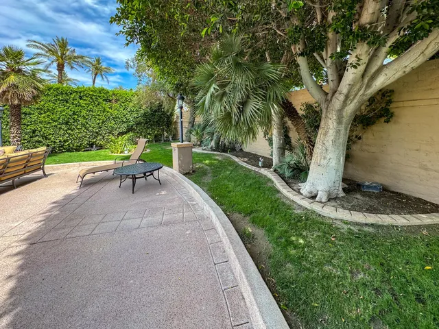 a view of a backyard with sitting area