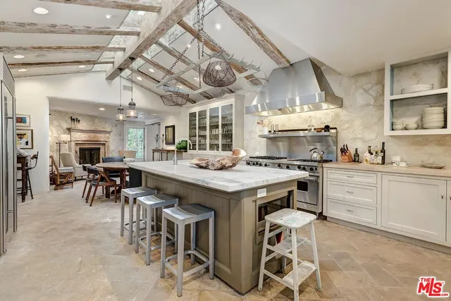 a kitchen with stainless steel appliances granite countertop a stove and cabinets