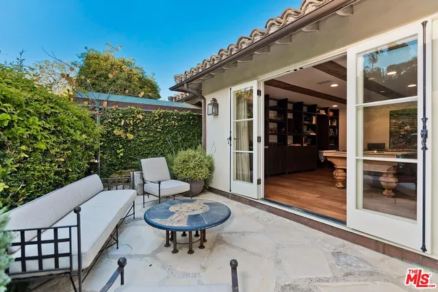 a view of a patio with table and chairs with wooden floor and fence