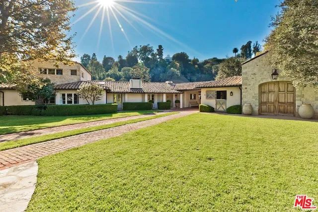 a view of house with outdoor space and swimming pool
