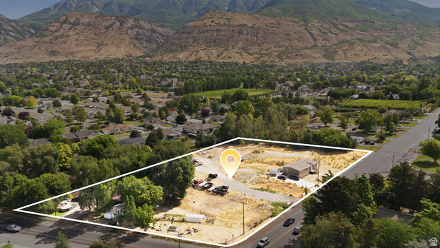 426 North Locust Avenue Lindon, UT 84042 - Photo 1 of 9 Expansive land parcel featuring a single-story dwelling, paved driveway, and established trees