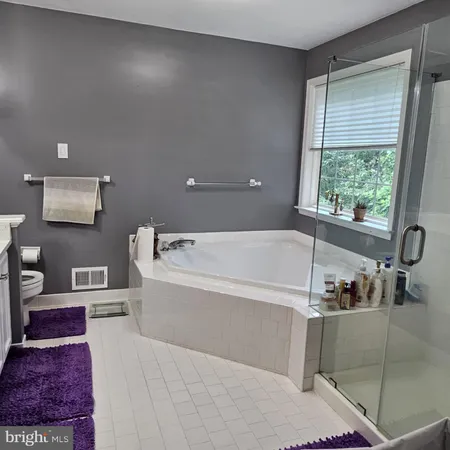 a spacious bathroom with a bathtub and next to a window