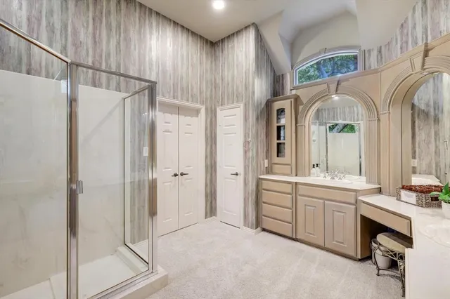 a bathroom with a double vanity sink a mirror and a shower