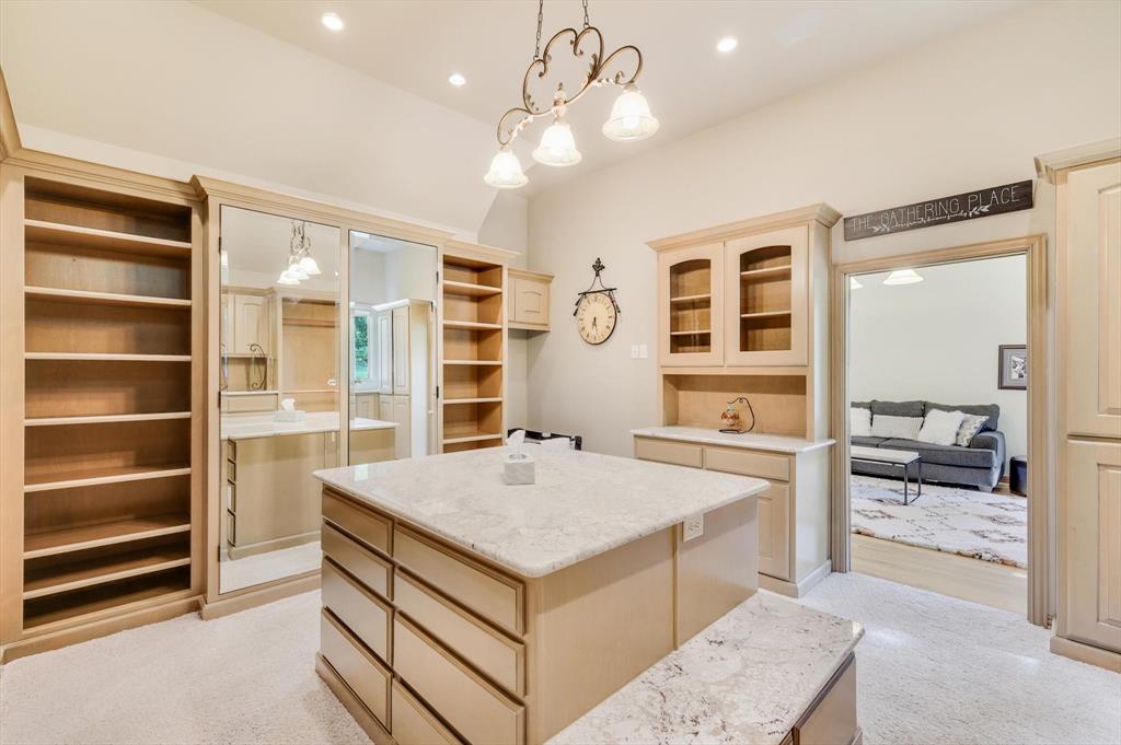 2740 High Road Flower Mound, TX 75022 - Photo 18 of 35 a living room with a large bed and cabinets