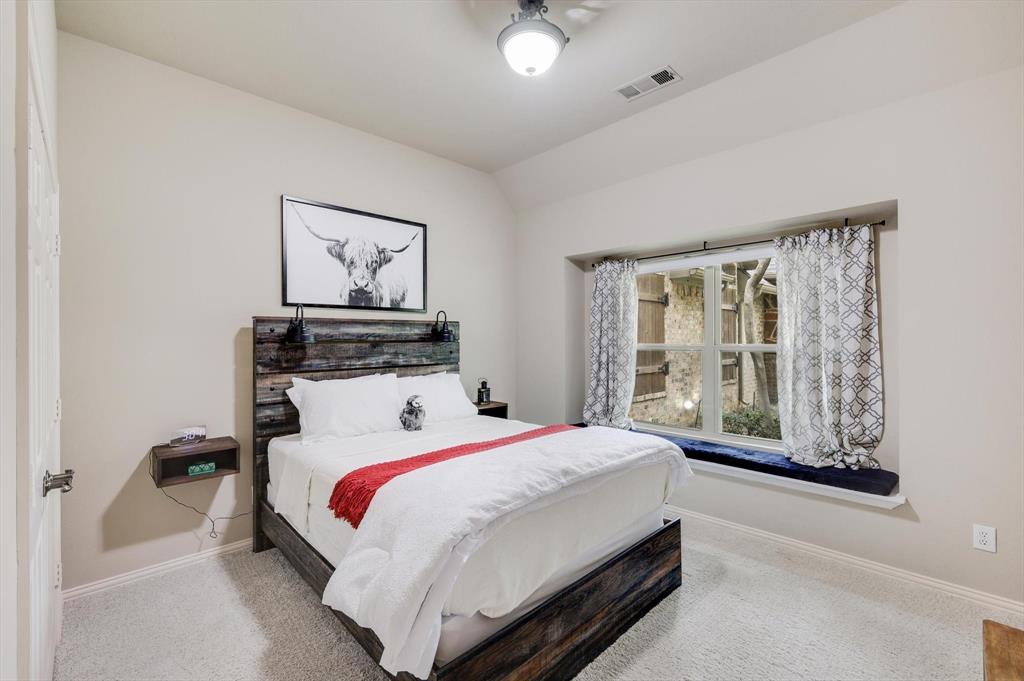 2740 High Road Flower Mound, TX 75022 - Photo 22 of 35 a bedroom with a bed and window