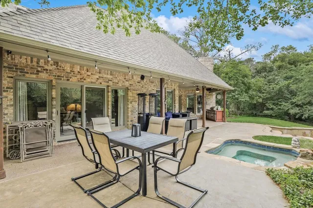 a view of a patio with table and chairs and potted plants