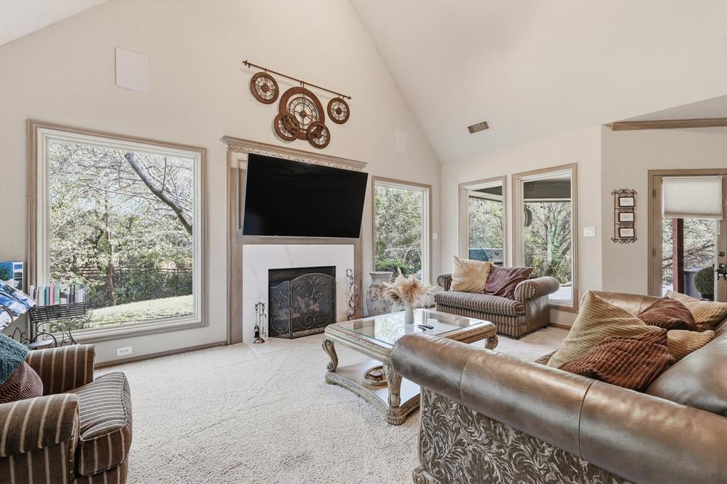 2740 High Road Flower Mound, TX 75022 - Photo 7 of 35 a living room with furniture a flat screen tv and a fireplace