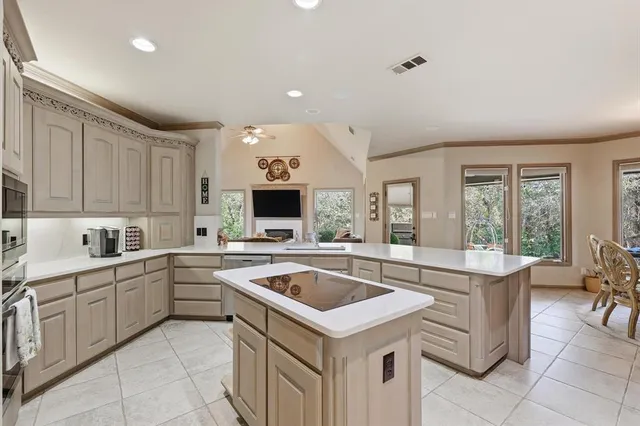 a kitchen that has a sink and a stove in it