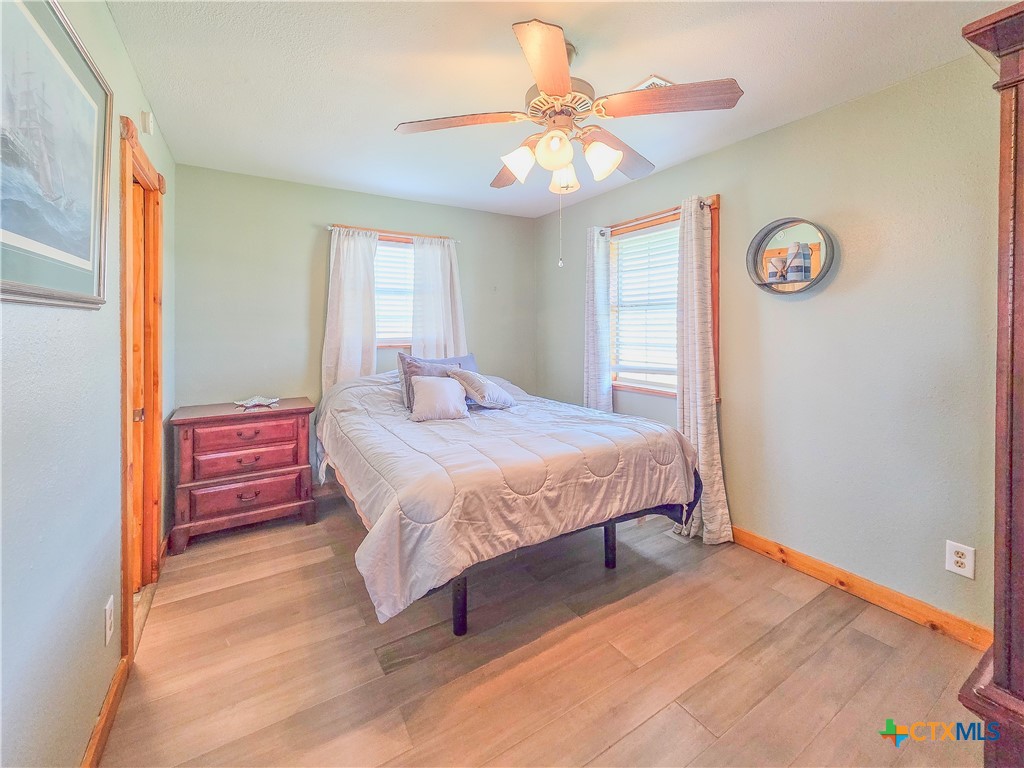 376 Haddock Drive Palacios, TX 77465 - Photo 16 of 41 a bedroom with a bed and a chandelier
