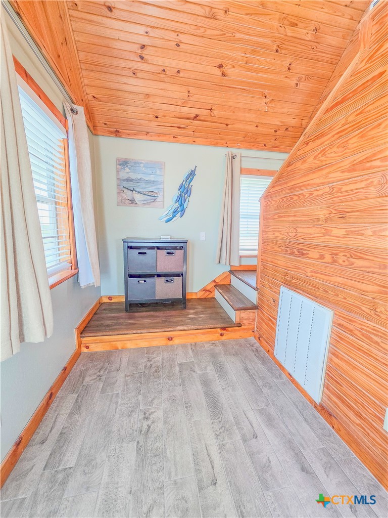 376 Haddock Drive Palacios, TX 77465 - Photo 22 of 41 a view of a room with wooden floor and chair