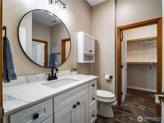 a bathroom with a toilet sink and mirror