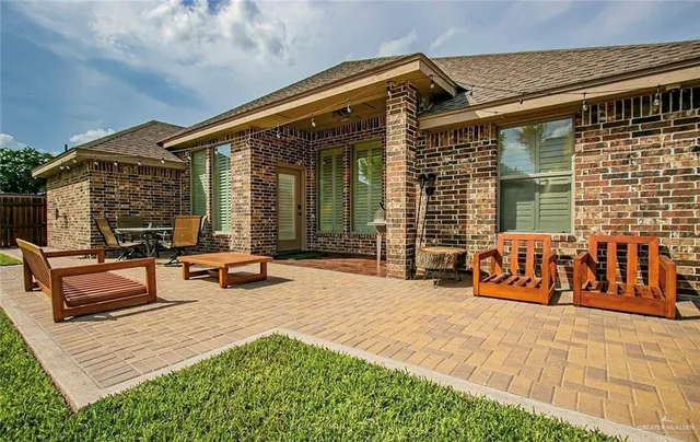 a view of a patio with table and chairs with wooden floor and fence