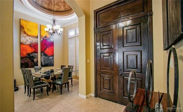 a view of a dining room with furniture and chandelier