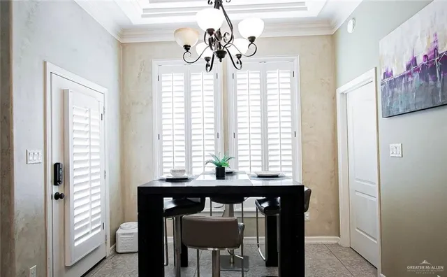 a view of a dining room with furniture chandelier and a window