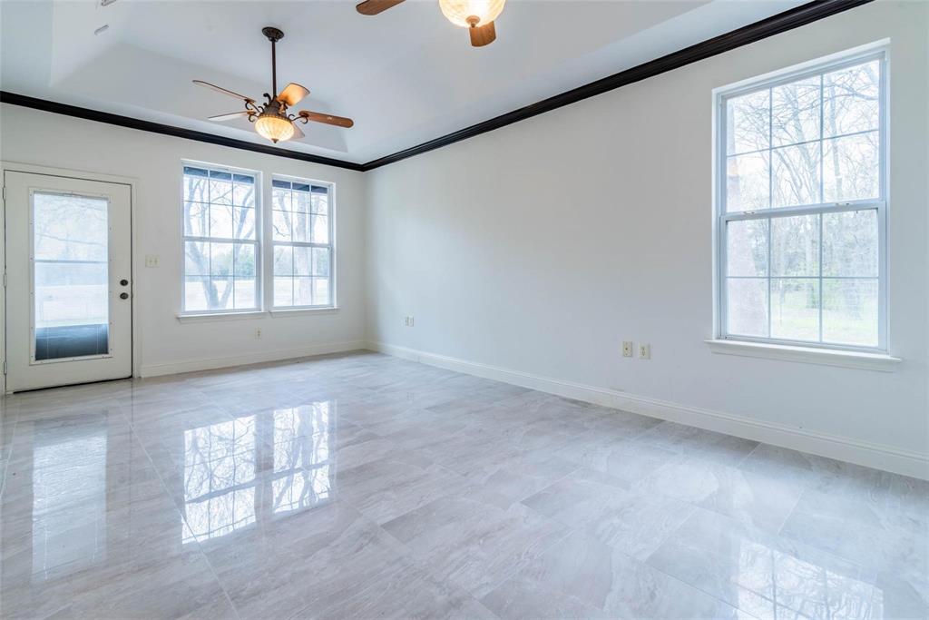 16301 Highway 121 Blue Ridge, TX 75424 - Photo 11 of 27 an empty room with windows and fan