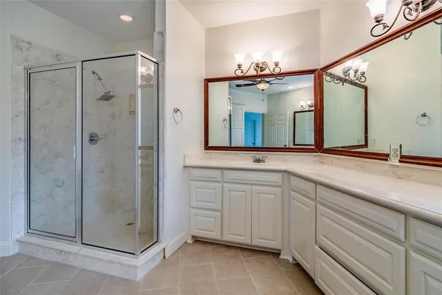 a bathroom with a shower sink and mirror