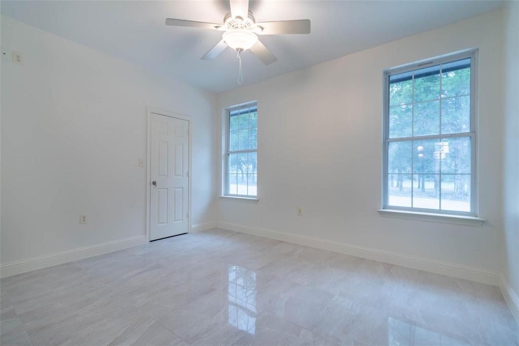 16301 Highway 121 Blue Ridge, TX 75424 - Photo 21 of 27 an empty room with windows and fan