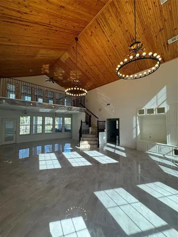 a view of a porch with a table and chairs