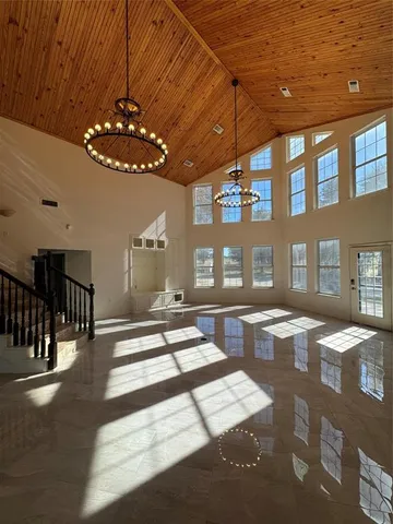 a view of a dining room with furniture chandelier and wooden floor