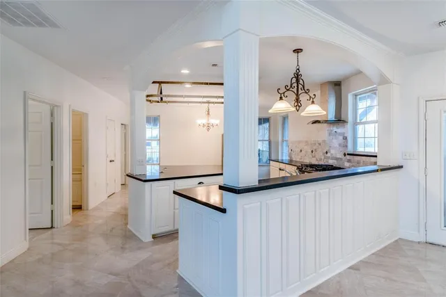 a kitchen with stainless steel appliances a refrigerator and cabinets