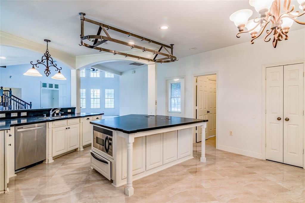 16301 Highway 121 Blue Ridge, TX 75424 - Photo 7 of 27 a kitchen with granite countertop a sink and cabinets