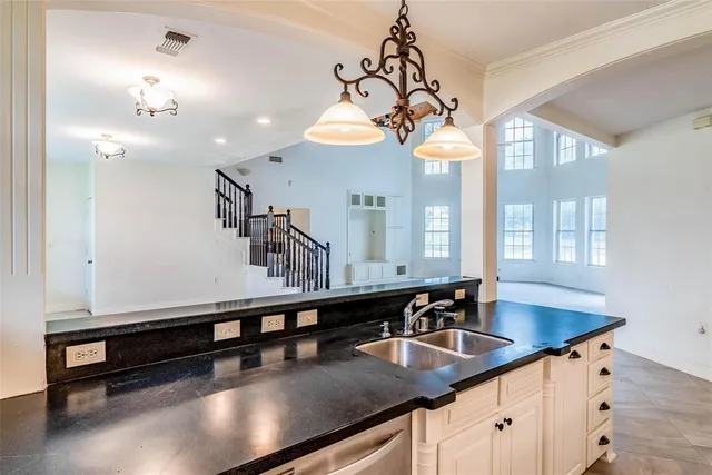 a kitchen with kitchen island a sink appliances and a counter top space