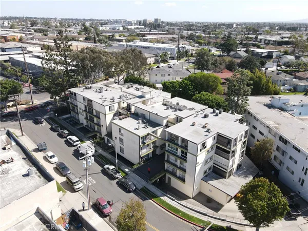 a view of a house with a car park on the side of a road