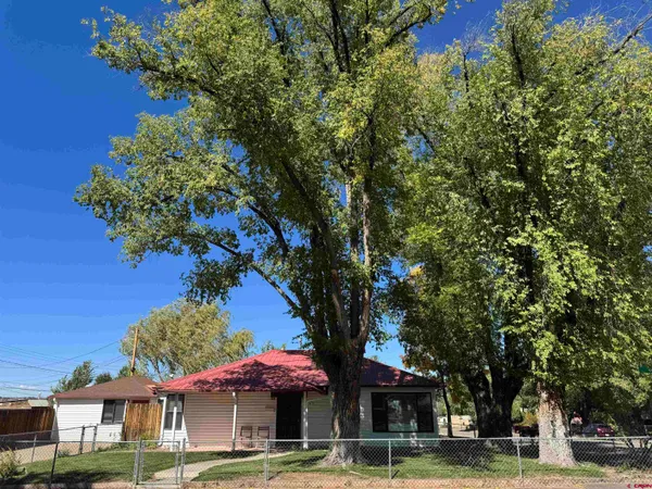 a front view of a building with tree s