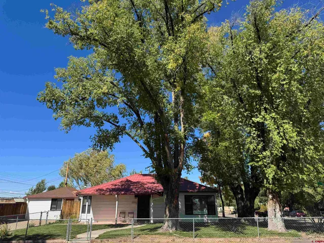 a front view of a building with tree s