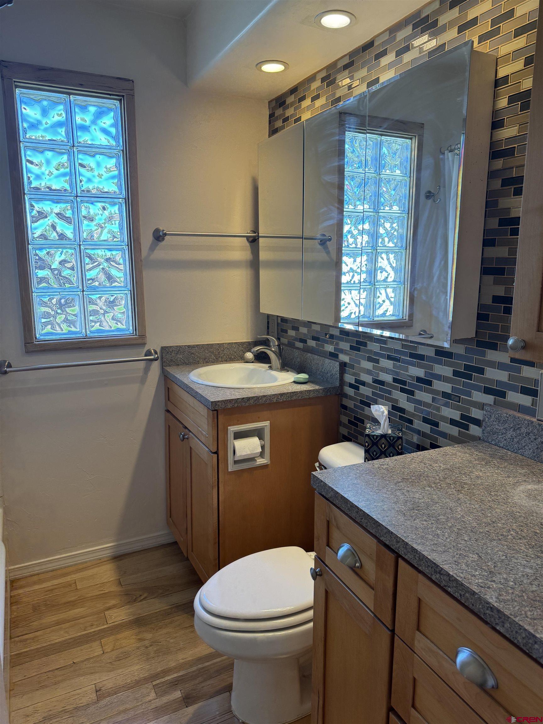 210 West Coronado Avenue Cortez, CO 81321 - Photo 13 of 41 a bathroom with a granite countertop toilet sink and mirror