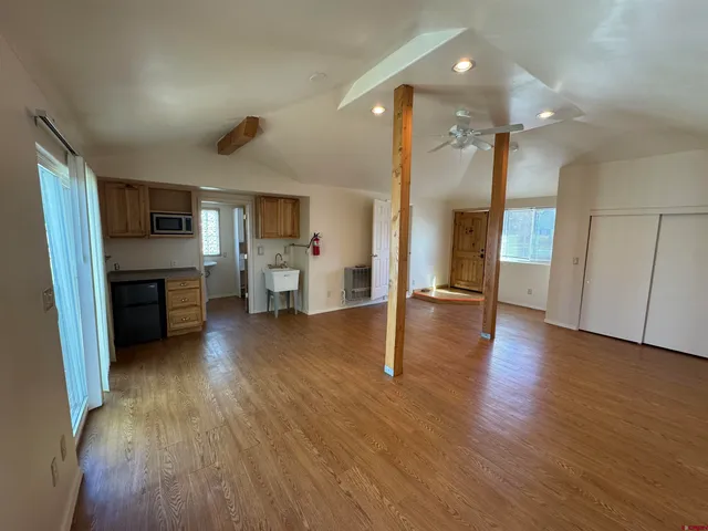 a view of a kitchen with a sink and a refrigerator