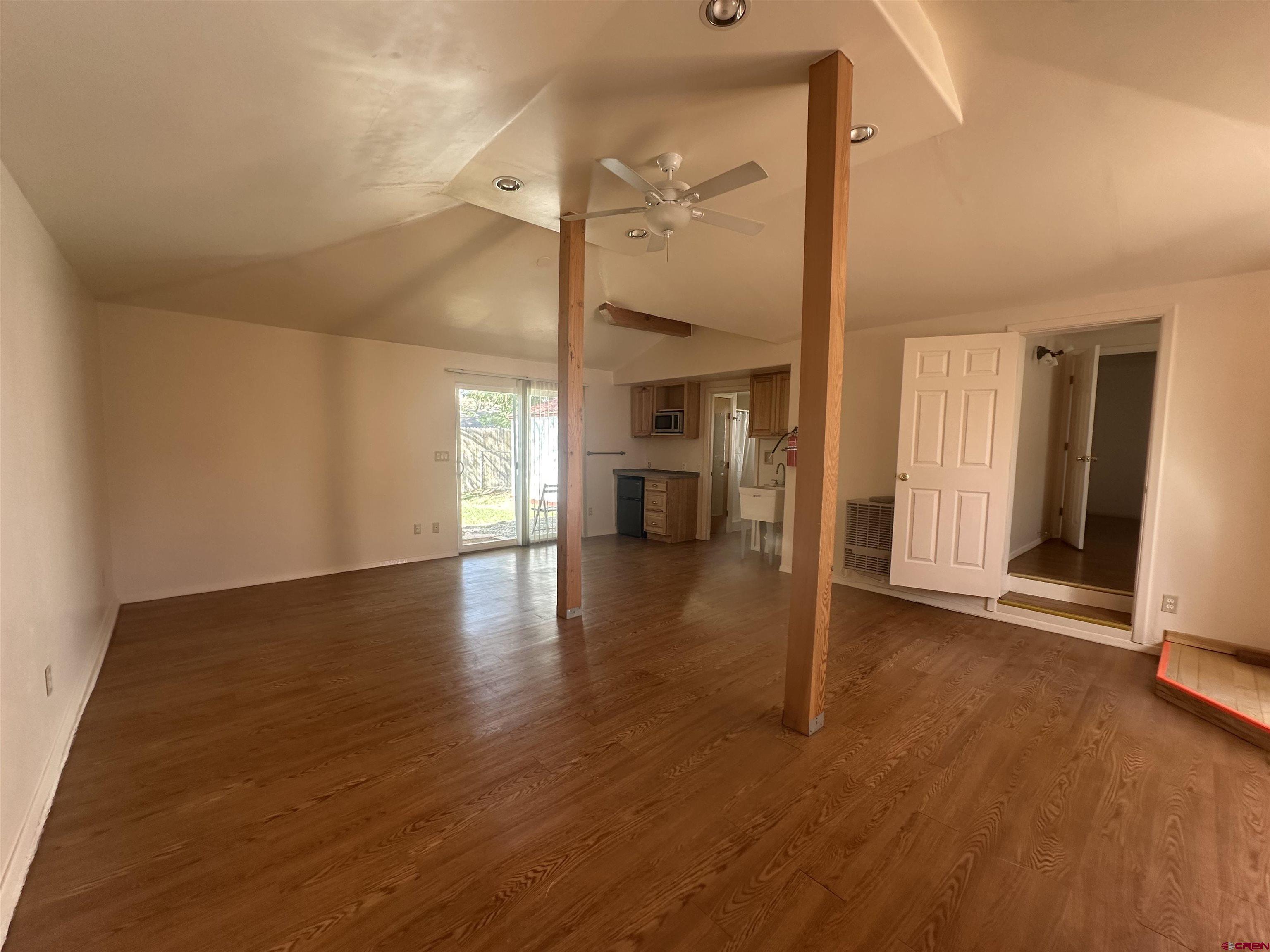 210 West Coronado Avenue Cortez, CO 81321 - Photo 16 of 41 a view of an empty room with wooden floor and a window