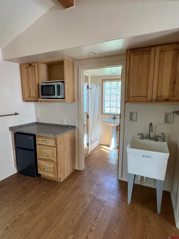 a kitchen with a refrigerator and a stove top oven