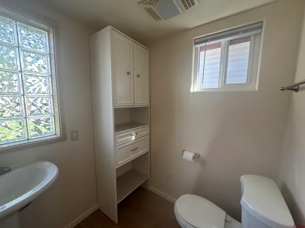 a bathroom with a toilet sink and mirror