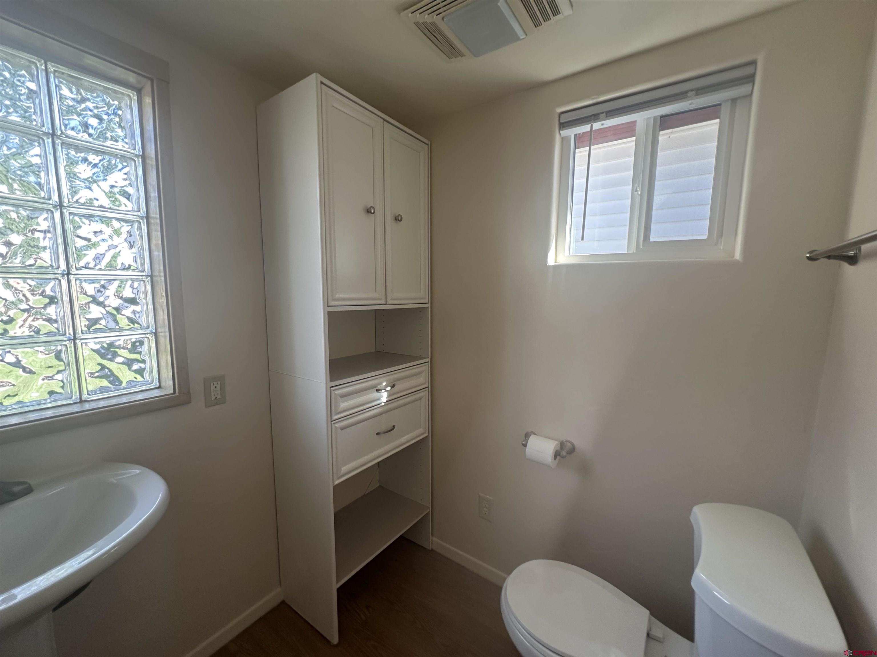 210 West Coronado Avenue Cortez, CO 81321 - Photo 18 of 41 a bathroom with a toilet sink and mirror