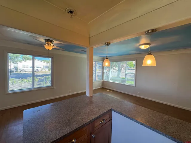 a kitchen with a sink and dishwasher next to a window