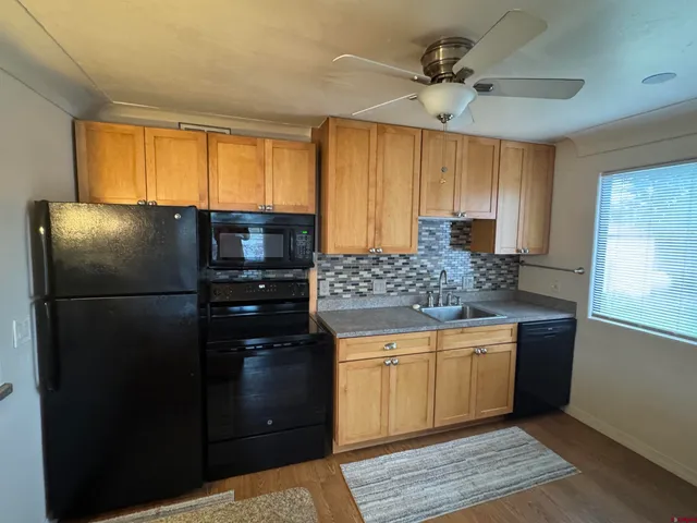a kitchen with a refrigerator and a sink
