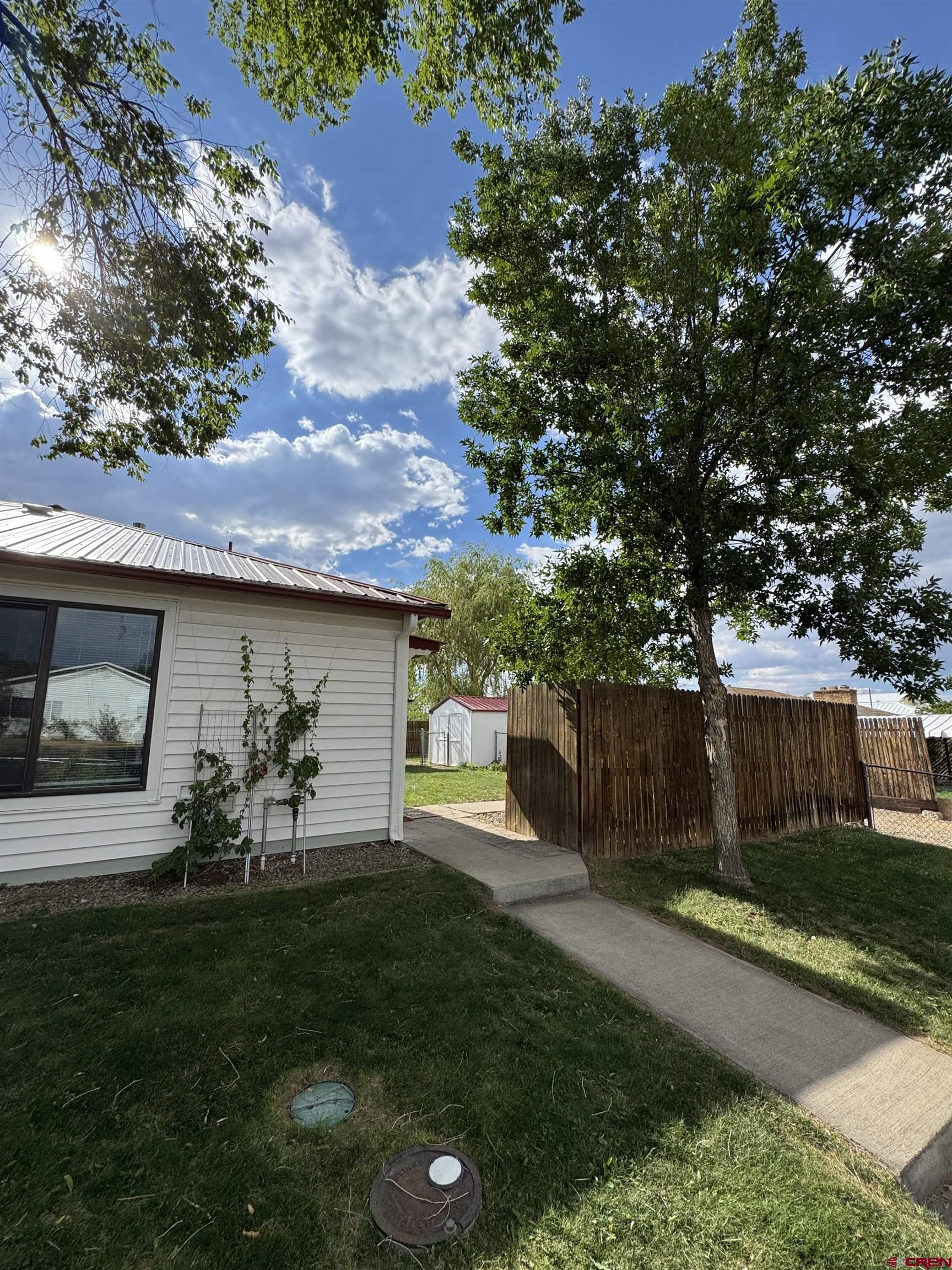 210 West Coronado Avenue Cortez, CO 81321 - Photo 33 of 41 a view of a backyard with a garden and plants