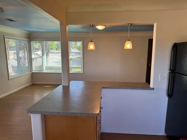 a view of a kitchen with a sink and a window
