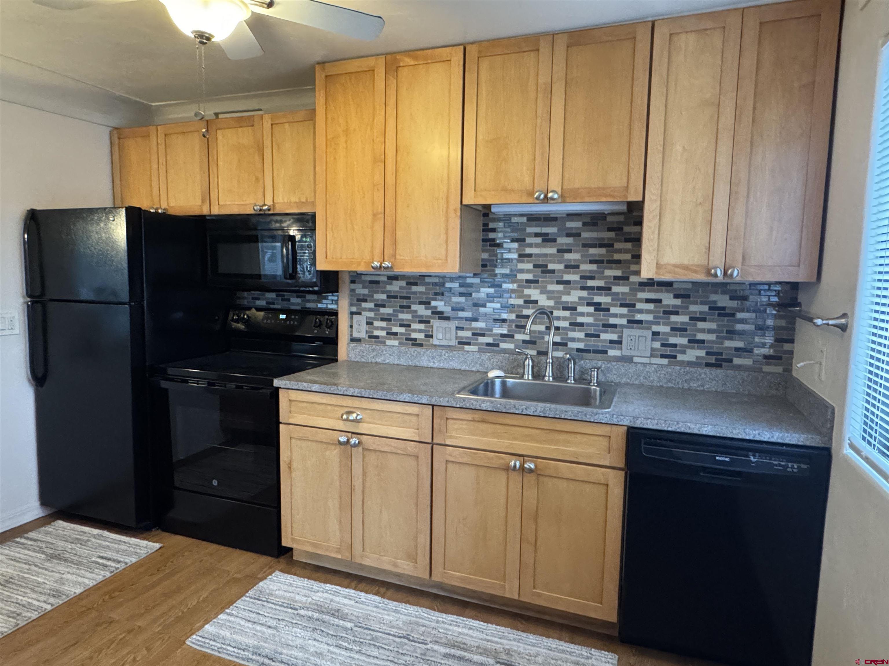 210 West Coronado Avenue Cortez, CO 81321 - Photo 41 of 41 a kitchen with a sink a refrigerator and cabinets
